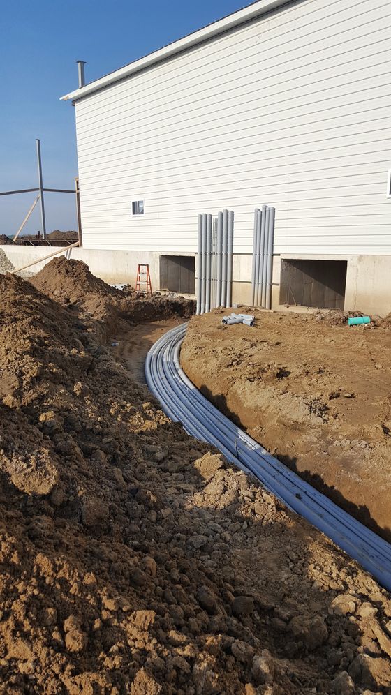 Underground conduit runs in a trench to a new commercial building in Warsaw, Indiana, installed by McClone Electric