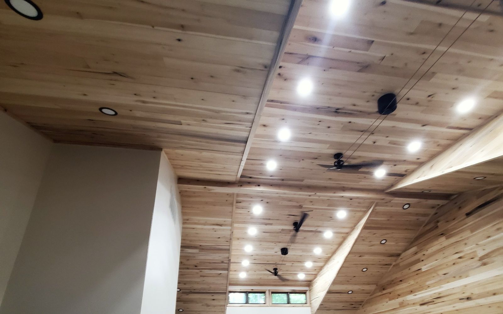 Recessed lighting in a vaulted wood ceiling, installed by McClone Electric